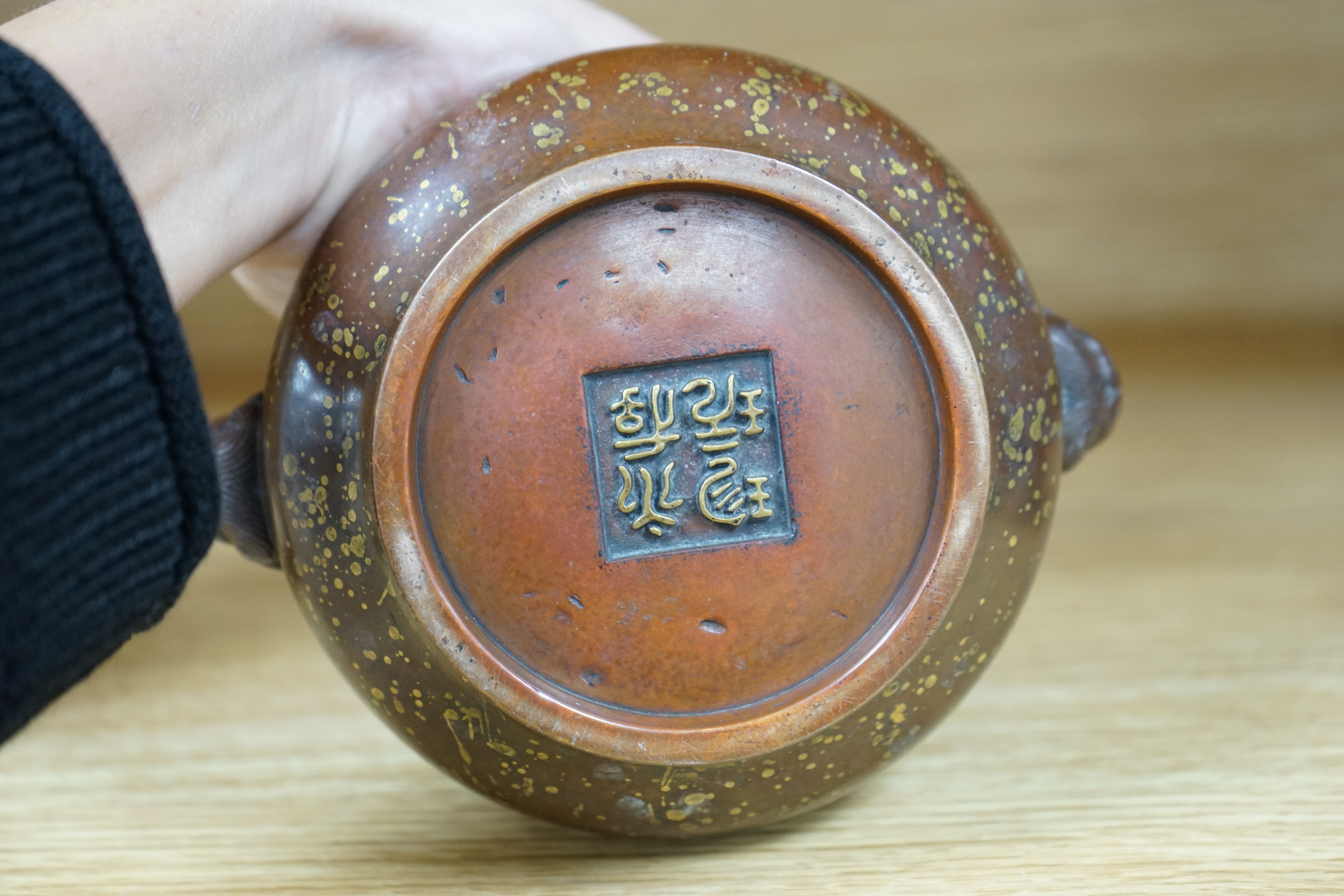 A Chinese gold splashed bronze censer, gui, four character mark, 9cm high. Condition - good